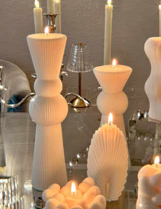 A lit Enzo XXL Pillar Candle Set of 2.