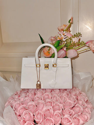 Victoria Handbag Resin Vase atop a massive pink bouquet.