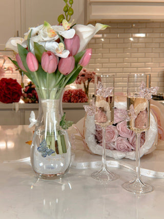 Butterfly Whispers Glass Vase next to Anais' Butterfly Dreams Champagne Flutes