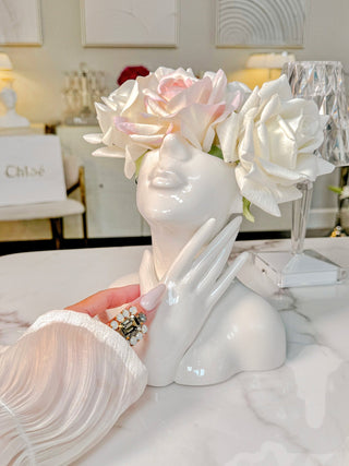 A woman showing off the Jovie Ceramic Vase.