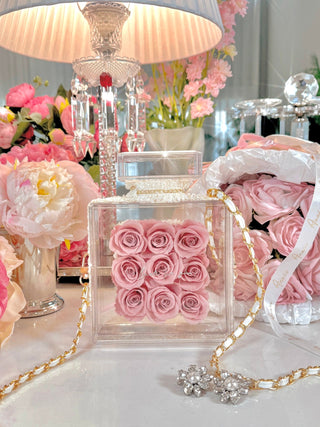 Everlasting Roses in Parfum Box in French Rose Pink surrounded by pink and white blooming florals.