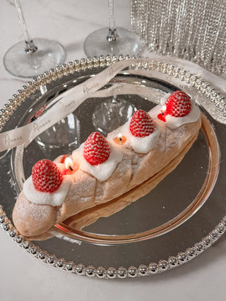 Strawberry & Cream Bread Candle atop a beautiful plate.