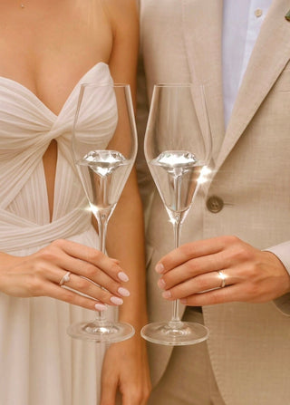A married couple toasts at their wedding with the ‘100-Carat’ Diamond Champagne Flute Set of 2™️.