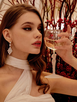 A lady peering into her Venus Goddess Sculpture Wine Flute.