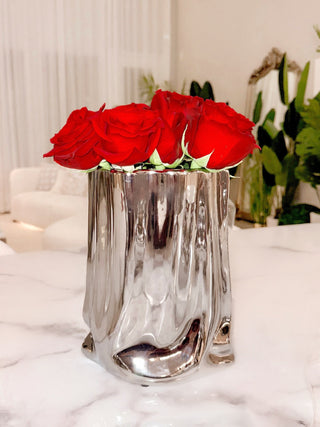 Luxe Bag Vase - Silver Electroplated on atop a luxurious marble dining table.