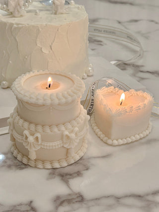 Double Layer Creamy Vintage Cake next to other Anaïs Candles.