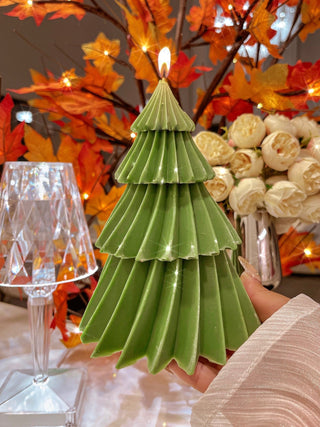 A woman holds a lit Pine Tree Candle - XXL in her Hollywood Hills living room.