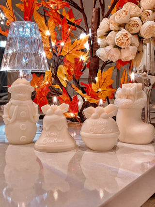 Christmas Wonderland Candle Set of 4 in White displayed in an autumn and Christmas setting.