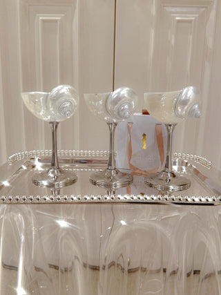 A trio of seashell enchant cups next to an Anais Jewelry box.