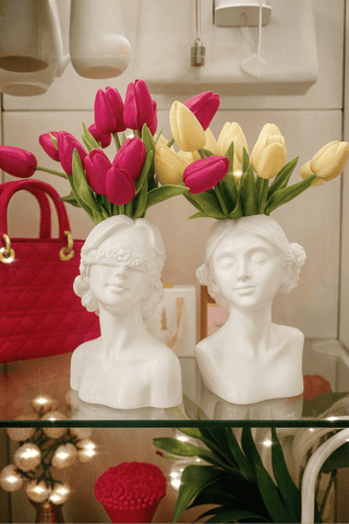 The "Rose & Ruby" Lady Ceramic Vase Set of 2 set atop a Carrara marble dining table.