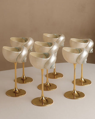 Three beautiful sets Seashell Enchanté Cup™️ Set of 2 in Gold filled with delicious sparkling champagne on a Summer day.