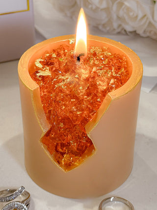 A close up of a lit 18K Gold Citrine Crystal Candle – Prosperity & Success.