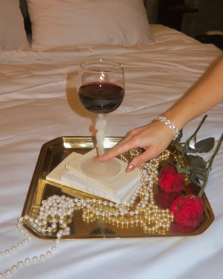 A Venus Goddess Sculpture Wine Flute on a high-end hotel's room service tray.
