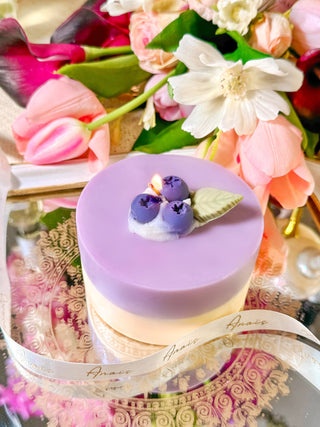 A Blueberry Cheese Cake Candle handcrafted with all-natural soy and beeswax.