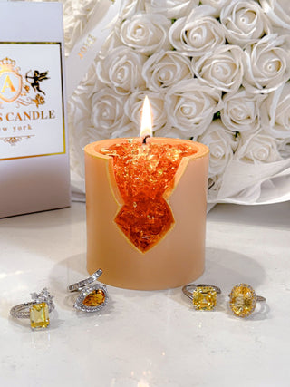 An 18K Gold Citrine Crystal Candle styled in a beautiful living room.