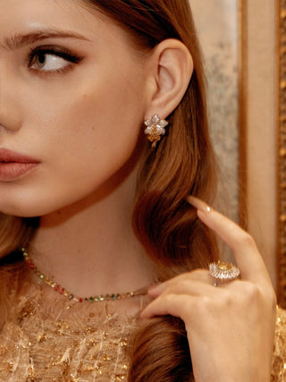 Rosemary Floral Yellow Sapphire Rhinestone Earrings worn by a model, left ear.