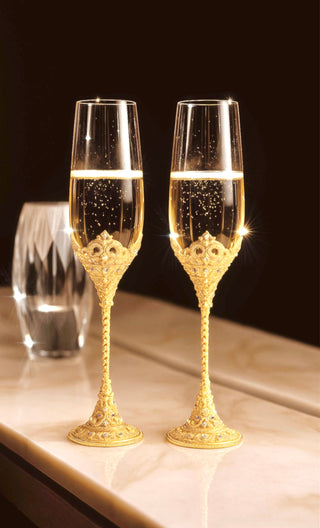Crowné Embossed Diamonds Champagne Flutes in Gold on a marble console table.