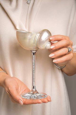The Seashell Enchanté Cup™️ featuring a stem filled with small shimmering crystals.