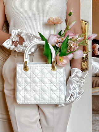 Woman holding Scarlett Resin Handbag Vase while standing.