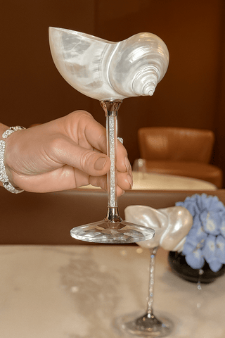 The Seashell Enchanté Cup™️ Set of 2 in Crystal in a fine dining establishment.