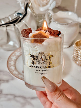 A close up of a lit Chocolate Bear & Cookies Latte Candle.