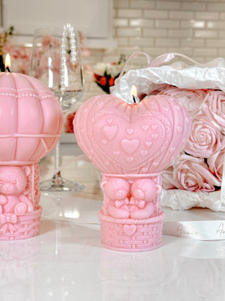 Balloon Bear Candle Set of 3 in French Rose Pink atop a marble dining table.