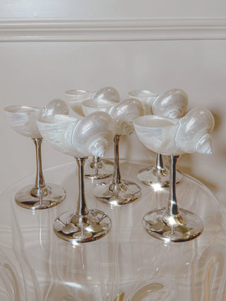 Six Seashell Enchanté Cups™️ in a luxurious hotel setting.