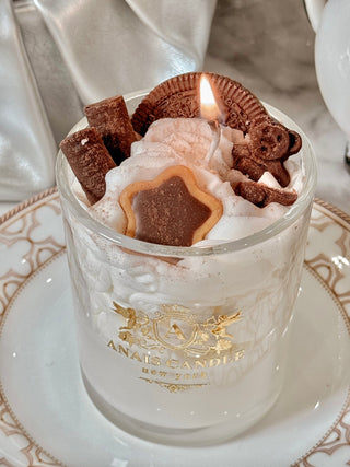 A lit Chocolate Bear & Cookies Latte Candle.