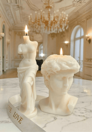 The Anais Man & Venus Candle Set in Sculpture White, pictured in a luxurious 5 star hotel.