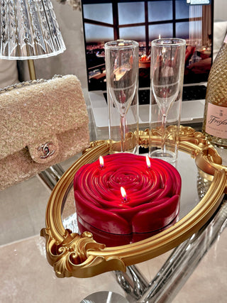 3-Wick Brilliant Rose Candle in Red decorated in a luxurious hotel room.