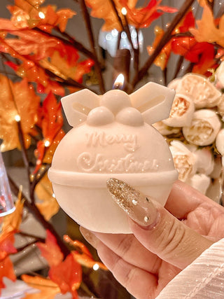 A lovely woman enjoying the scent of the Christmas Wonderland Candle Set of 4.