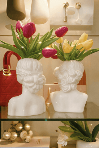 The "Rose & Ruby" Lady Ceramic Vase Set of 2 set atop a Carrara marble coffee table.