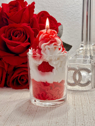 Strawberries & Cream Candle with a lit flame.
