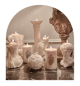 Greek sculpture candles on marble table.