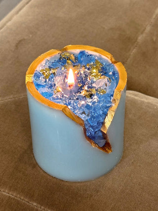 A close up view of the 18K Gold Blue Aquamarine Crystal Candle.
