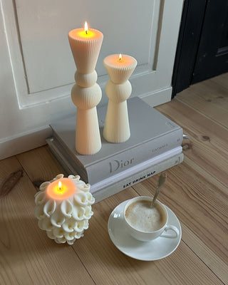Enzo XXL Pillar Candle Set of 2 placed atop luxury hardcover books.