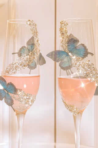 Close up of the Butterfly Kisses Crystals Champagne Flute Set with rose.