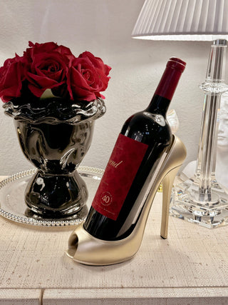 Golden Heeled Sandal Wine Holder with a bottle of red wine.