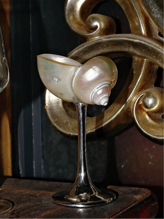A Seashell Enchanté Cup™️ in silver in a modern, rustic office.