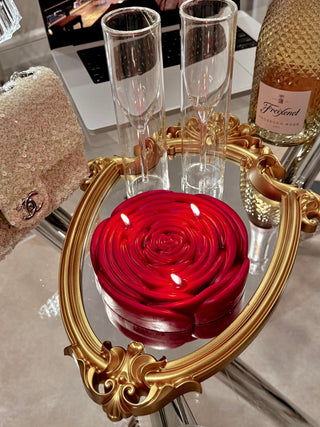 3-Wick Brilliant Rose Candle in Red atop an antique golden framed mirror tray.