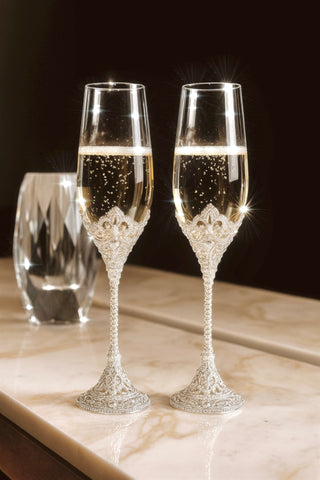 Crowné Embossed Diamonds Champagne Flutes in Silver on a marble console table.