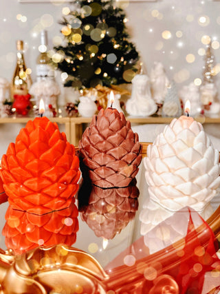 Holiday Lavish Pinecones Candle Set of 3 all lit next to each other.