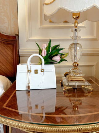 Victoria Handbag Resin Vase on a luxurious wooden desk.