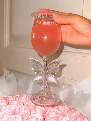 Dreamy Butterfly Champagne Flute Set of 2 atop a massive pink floral bouquet.