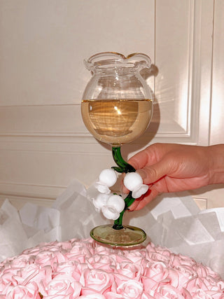 The ‘Lily of the Valley’ Sculpted Wine Glass atop a $2000 pink rose bouquet.