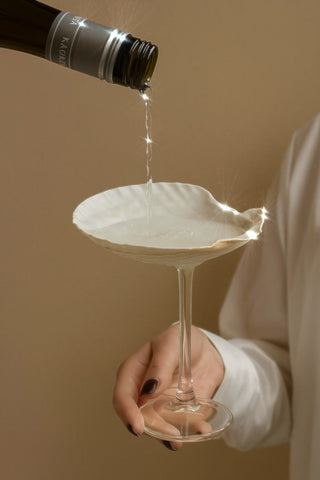 Pouring champagne in a Shelle Oceana Cup.