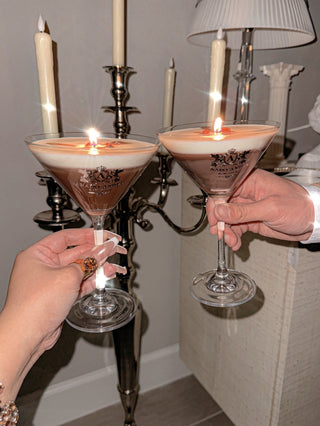 Two people toasting with the Lux Espresso Martini Candle.