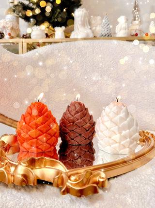 Holiday Lavish Pinecones Candle Set of 3 atop a beautiful fireplace.