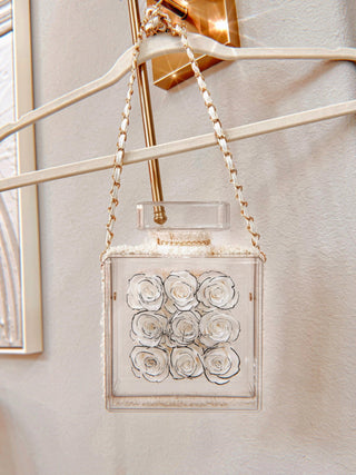 Everlasting Roses in Parfum Box - White hanging from a wall sconce.