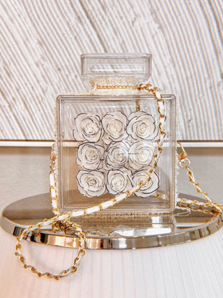 Everlasting Roses in Parfum Box - White placed atop a silver flat-topped lamp shade.